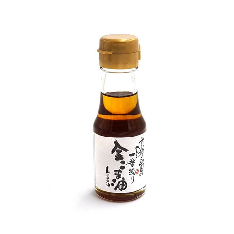 Gylden sesamolie 65 ml i original japansk glasflaske – autentisk japansk premium sesamolie fra Kyoto med fyldig nøddeagtig aroma, intens umami og traditionelt japansk håndværk i en praktisk 65 ml flaske.